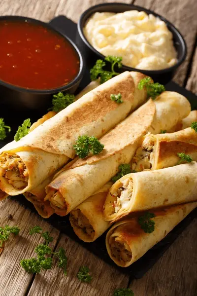 cheesy chicken taquitos with a crispy corn tortilla shell and flavorful chicken filling